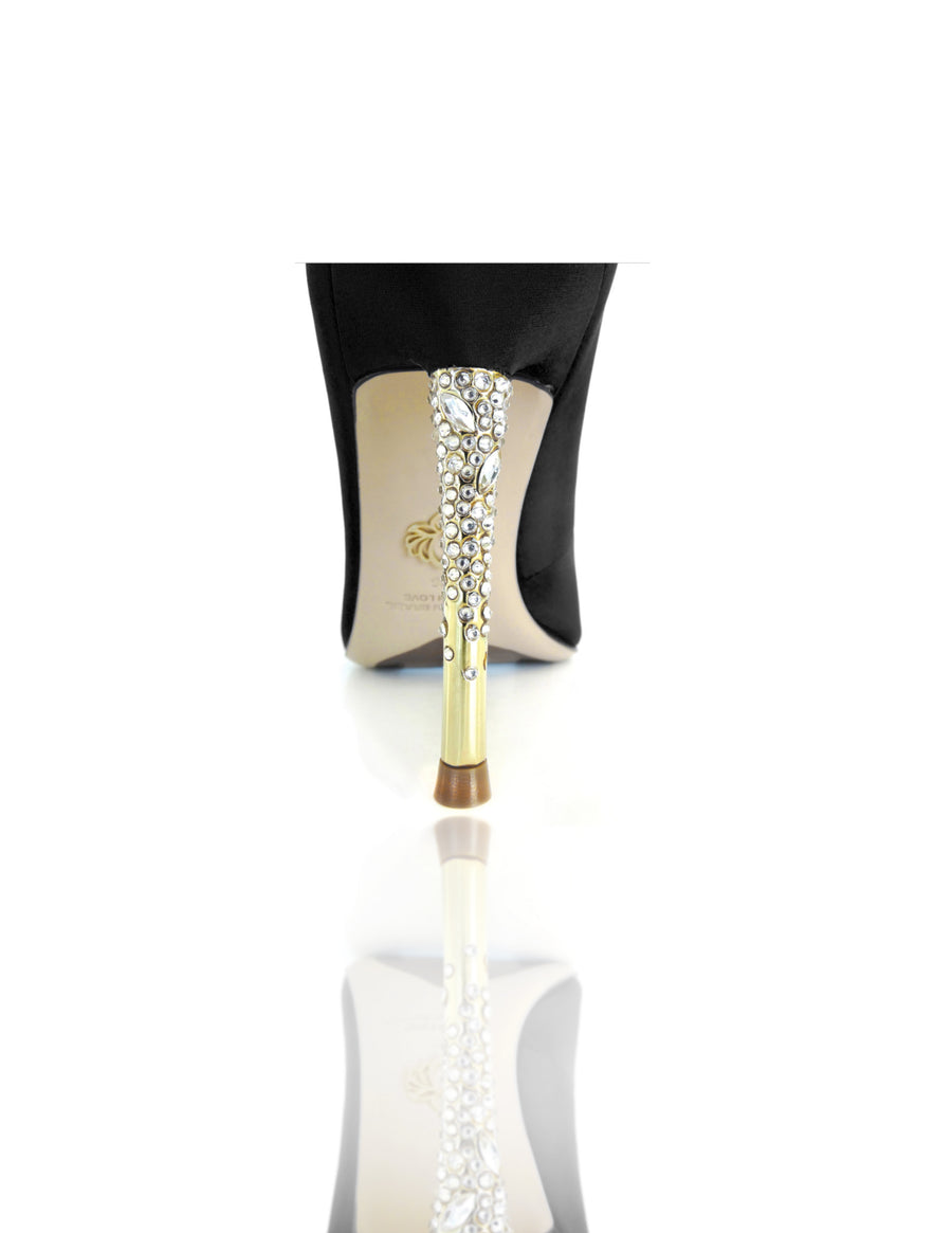 Nadia is a pointed toe pump with an opulent heel featuring clusters of Swarovski crystals that glitter while you walk. A rubber pod is recessed into the outsole to prevent slips. 4" or 100mm gold metal heel.