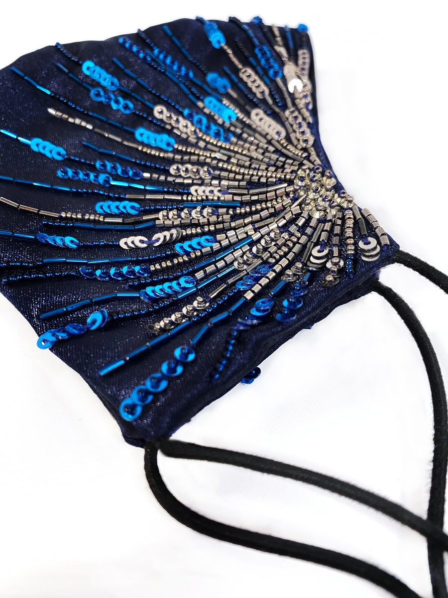 Celine fitted face mask in navy silk satin upper and cotton lining with starburst effect embroidery of sequins and beads. Adjustable elastic ear loops for best fit and cotton dust bag to keep her safe in your handbag. 